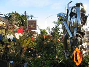 “Bumper to Bumper: Hula Girl” sculpture by Paulden , Laguna Nursery